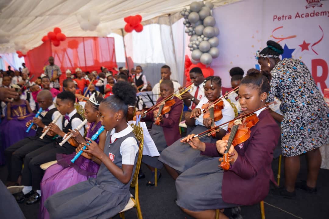 Petra Academy students performing in a musical group.